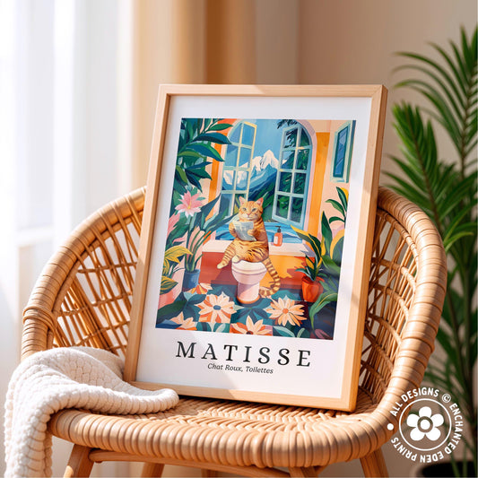 A framed print of a colorful illustration depicting a cat sitting on a windowsill, surrounded by tropical plants and flowers, with the text "MATISSE" and "Chat Rose, toiletettes" below.
