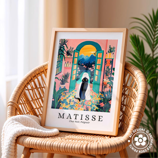 A framed poster of a colorful, whimsical illustration of a woman in a hat and dress, surrounded by tropical plants and flowers, is displayed on a wicker chair.