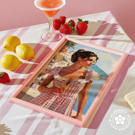 a framed painting of a woman in a red and white checkered dress, holding a drink, surrounded by a pink and white striped tablecloth, lemons, and strawberries.