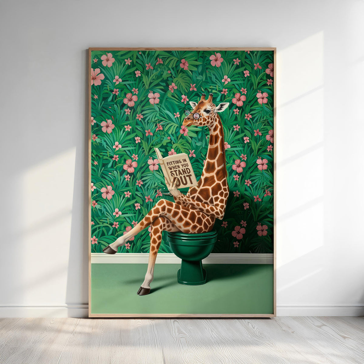 A giraffe sitting on a green toilet and reading a book, with a tropical floral background.