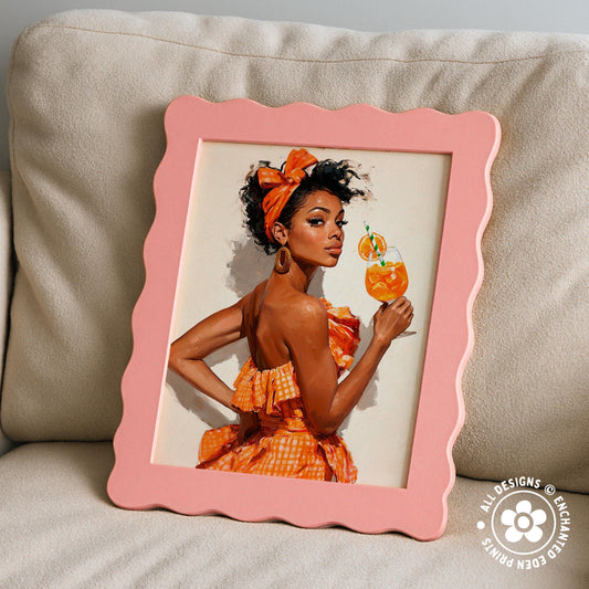 A framed painting of a woman in an orange dress holding a glass of orange juice, with a scalloped edge frame.
