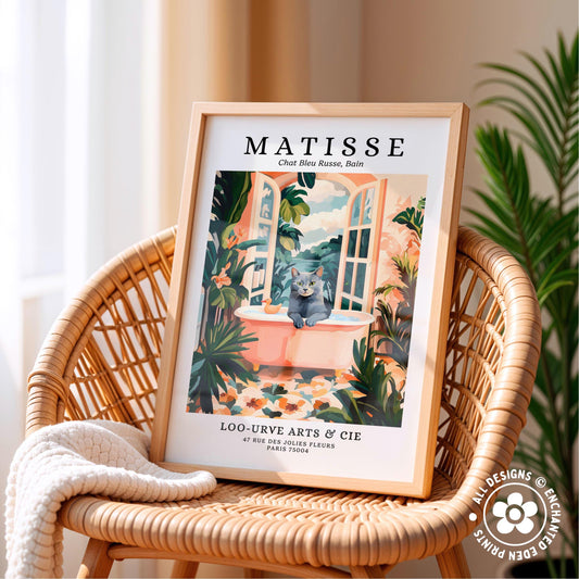 A framed poster of a cat sitting in a window, surrounded by tropical plants, is displayed on a wicker chair.