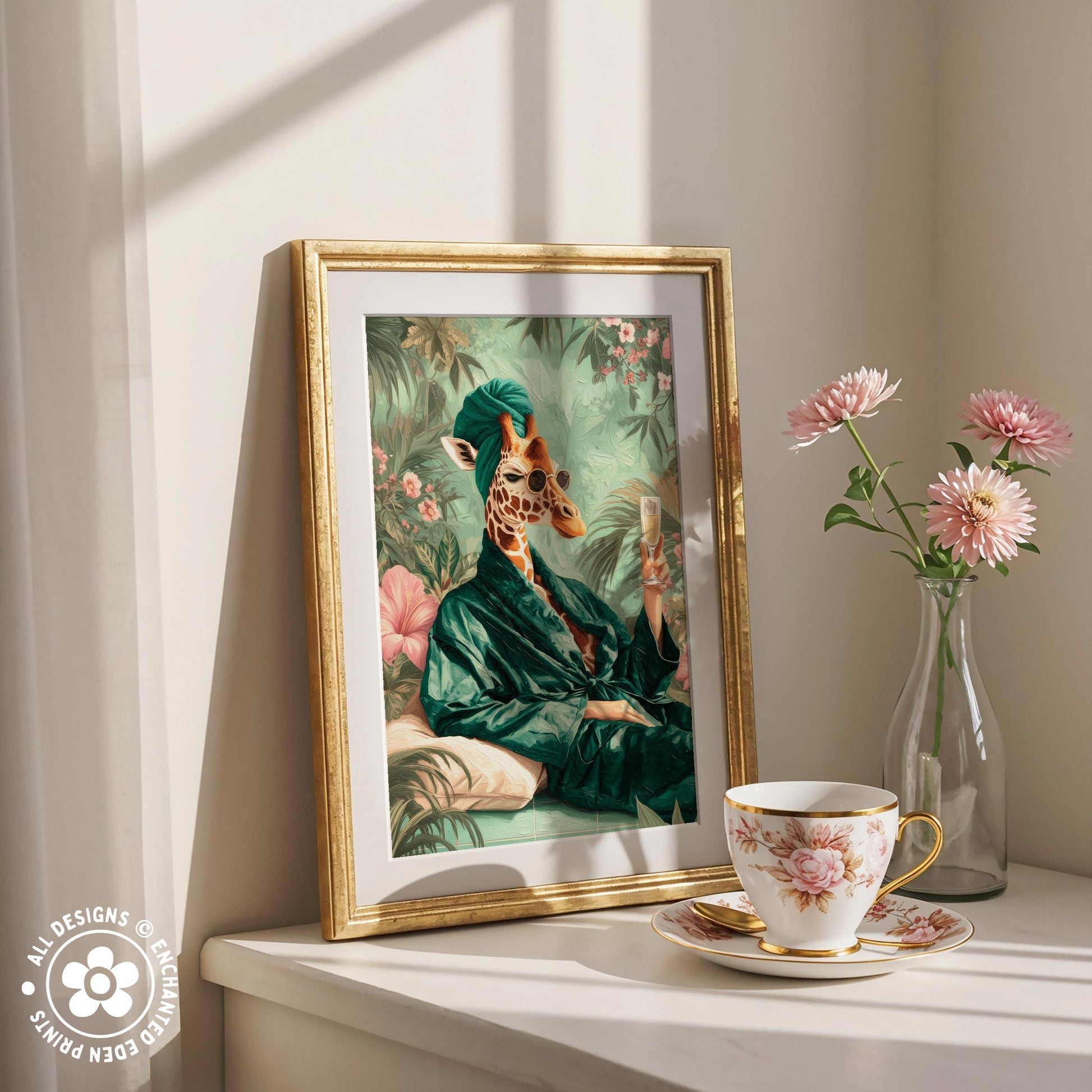 a framed painting of a giraffe wearing a green robe, sitting on a bench surrounded by flowers, with a cup of tea and a vase of pink flowers on a white shelf.