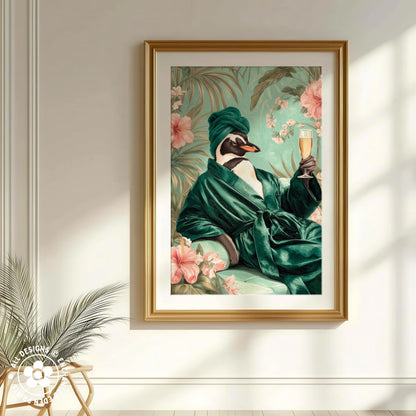 A framed painting depicting a penguin wearing a green robe and holding a glass of champagne, surrounded by tropical flowers.