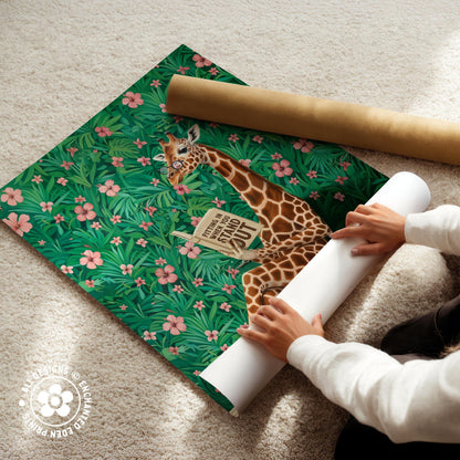 A person is unfolding a large roll of paper with a giraffe illustration on it, which is placed on a carpeted floor.