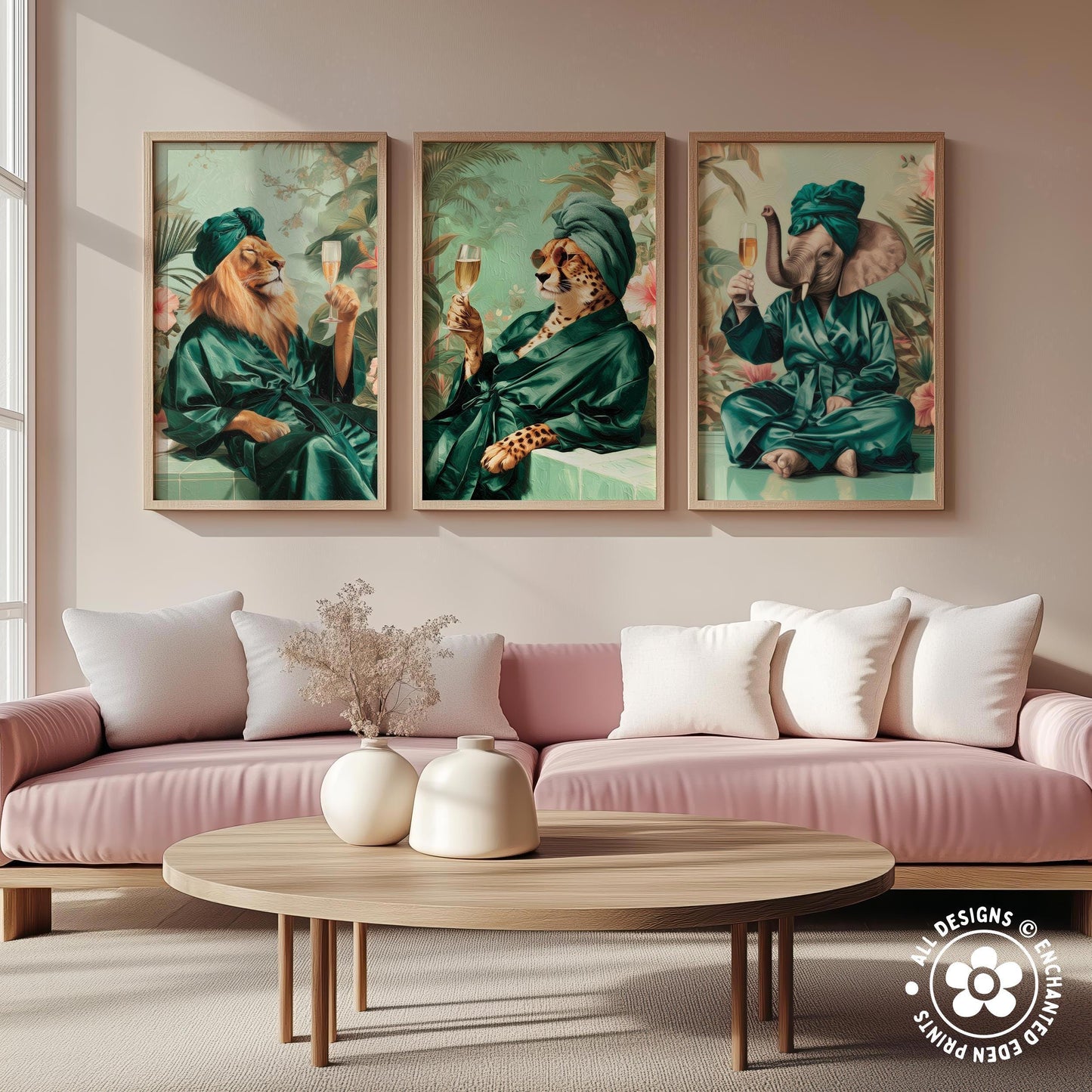 a living room with a pink sofa and a wooden coffee table. Above the sofa, there are three framed paintings depicting animals dressed in green robes, each holding a wine glass.