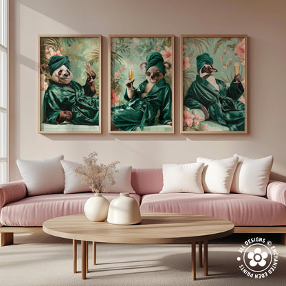 a cozy living room with a pink sofa and a wooden coffee table. Above the sofa, there are three framed pictures of pandas wearing green robes and holding drinks, creating a whimsical and stylish atmosphere.