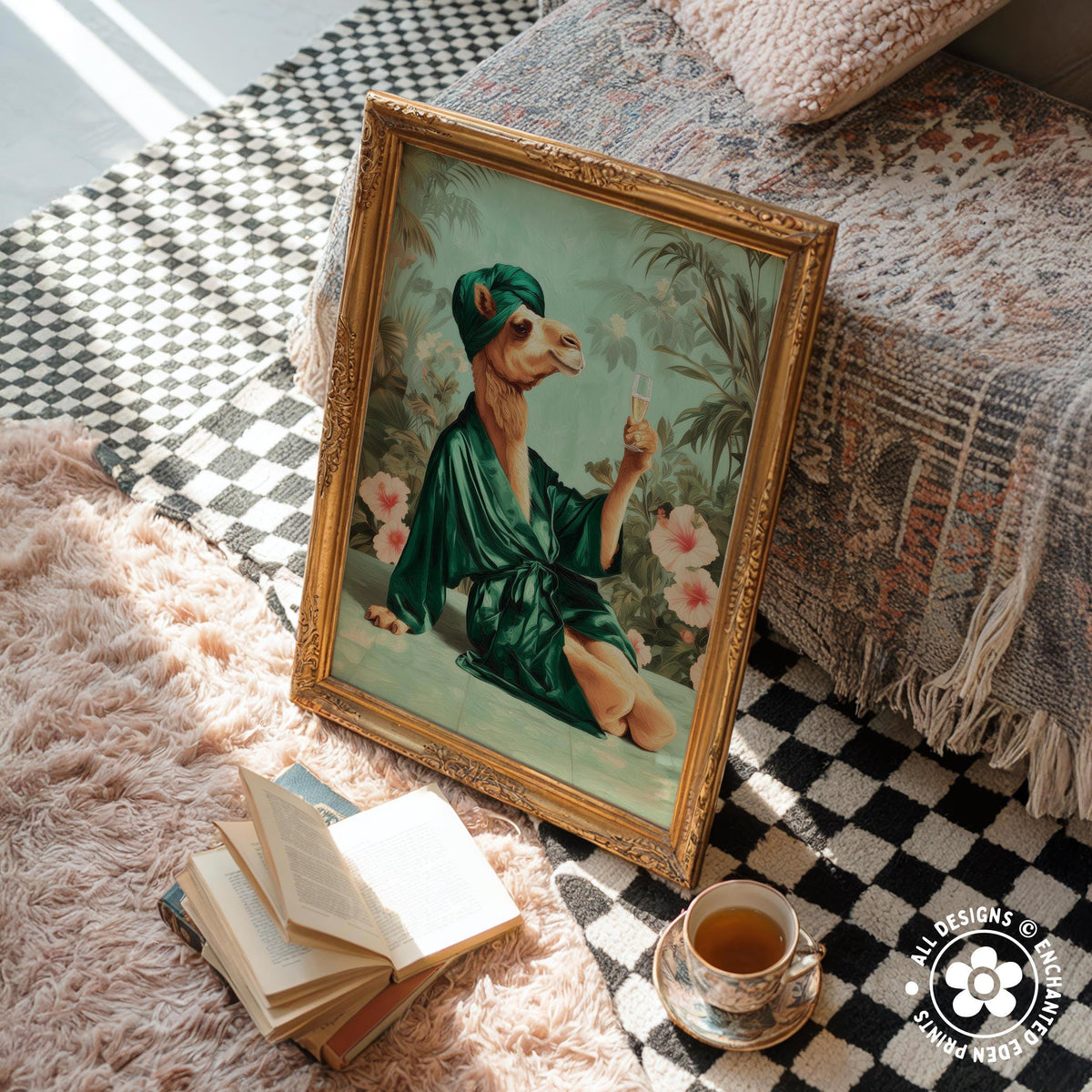 a framed painting of a camel dressed in a green robe, holding a drink, sitting on a bed with a checkered blanket. Next to the painting, there is a stack of books and a cup of tea on a pink shag rug.