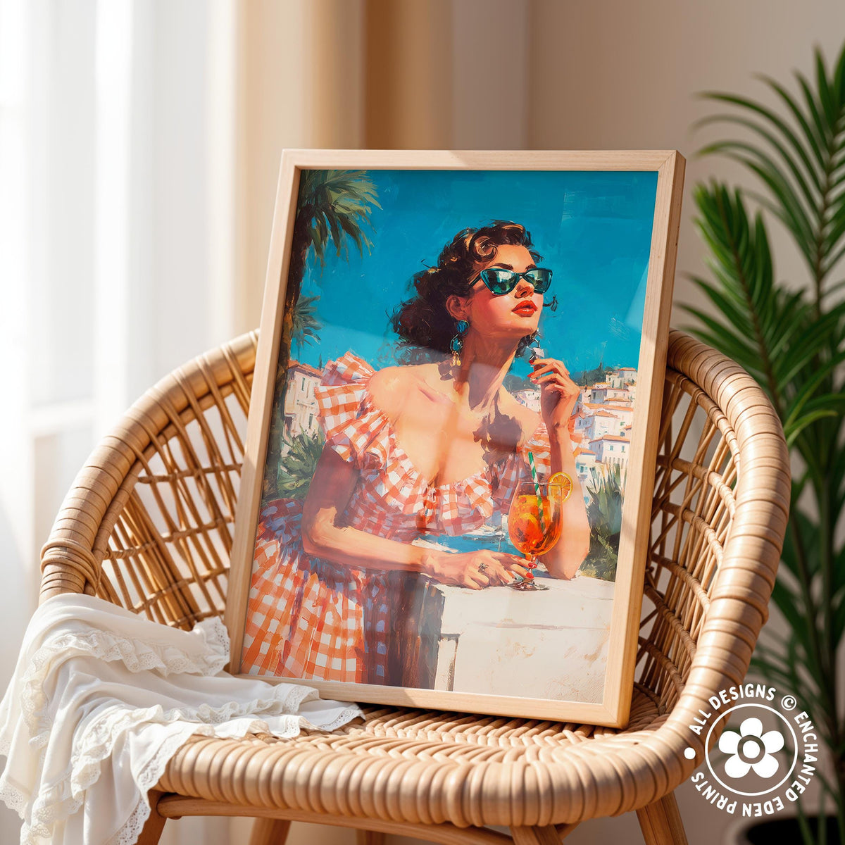 A framed painting of a woman in a red and white checkered dress, wearing sunglasses and holding a drink, is displayed on a wicker chair.