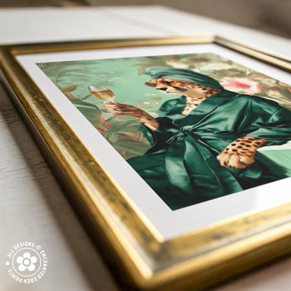 a framed artwork depicting a leopard wearing a green robe and holding a wine glass.