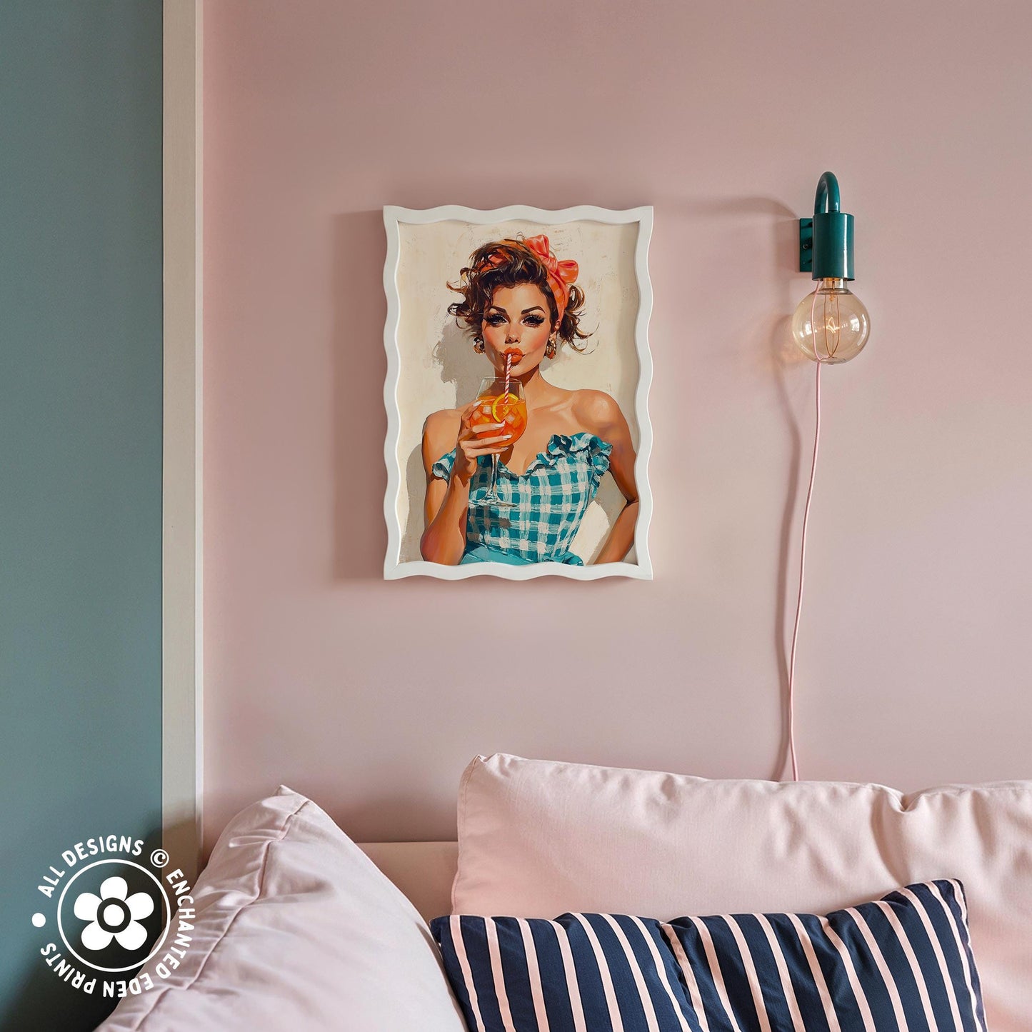 a framed vintage-style illustration of a woman holding a drink, hanging on a pink wall above a couch with striped pillows.