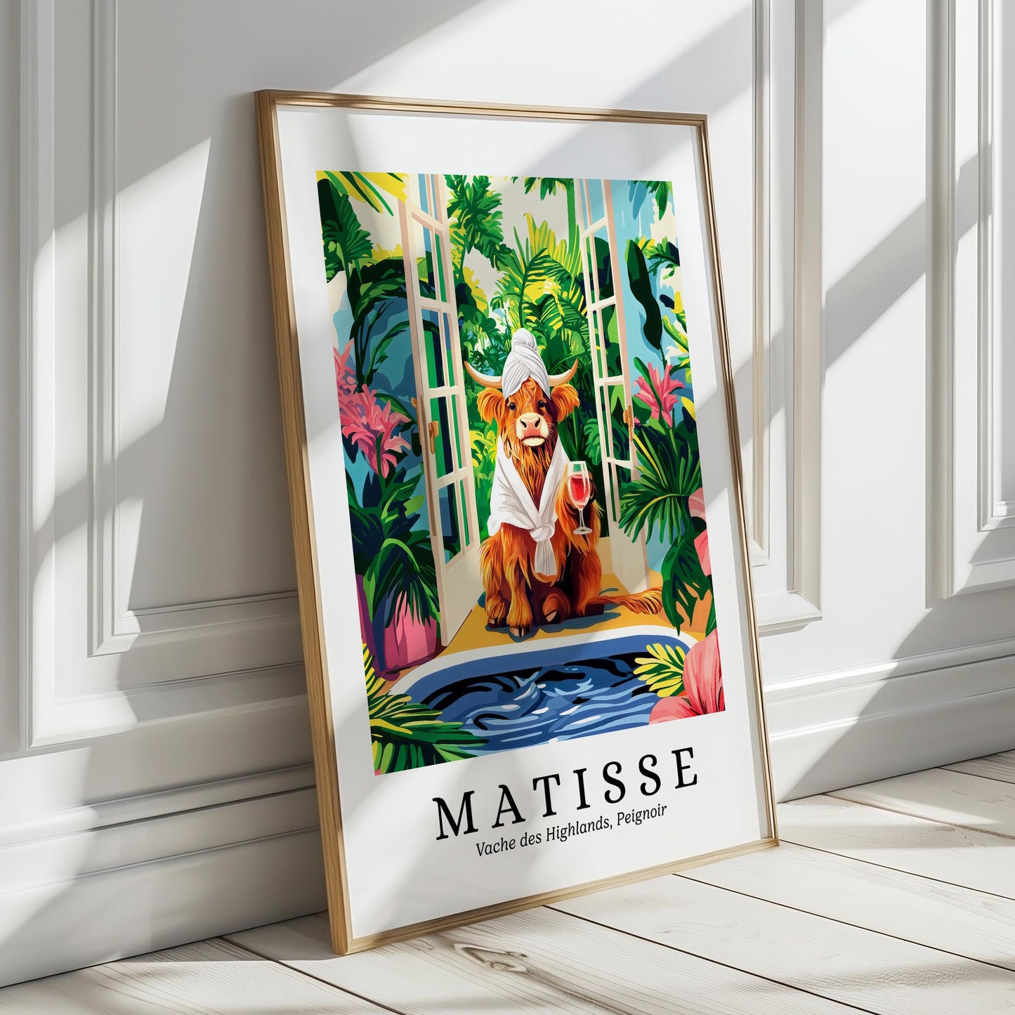 A framed poster depicting a cow wearing a white hat and holding a wine glass, surrounded by tropical foliage and a body of water, with the text "MATISSE" and "Vache des Highlands, Peigneur" below.
