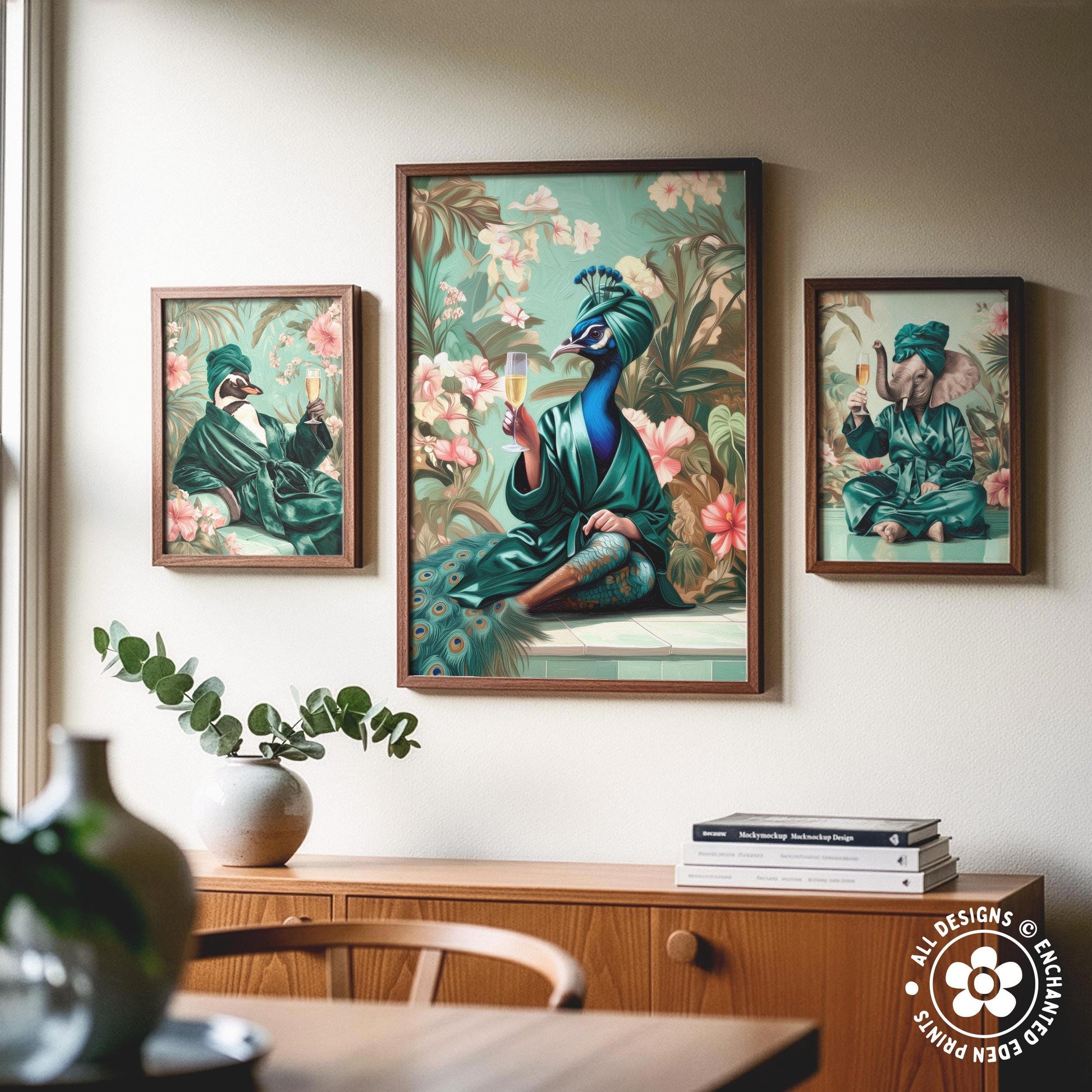 a wooden cabinet with a vase of greenery and a stack of books on top. Above the cabinet, there are three framed paintings depicting peacocks in various poses and settings.