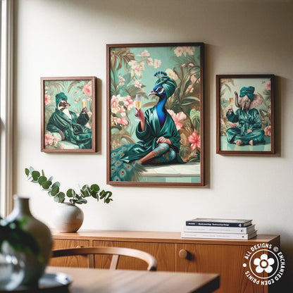 a wooden cabinet with a vase of greenery and a stack of books on top. Above the cabinet, there are three framed paintings depicting peacocks in various poses and settings.