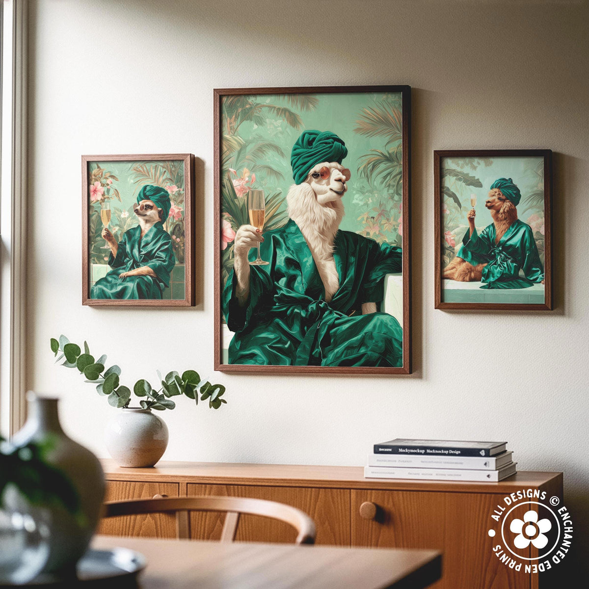 a framed artwork of a cat wearing a green robe and turban, holding a glass of wine, with two other framed images of cats in similar attire on either side of the central artwork.