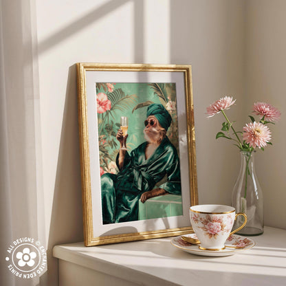 a framed painting of a person in a green robe holding a glass of wine, surrounded by pink flowers and a vase of pink flowers on a white shelf.