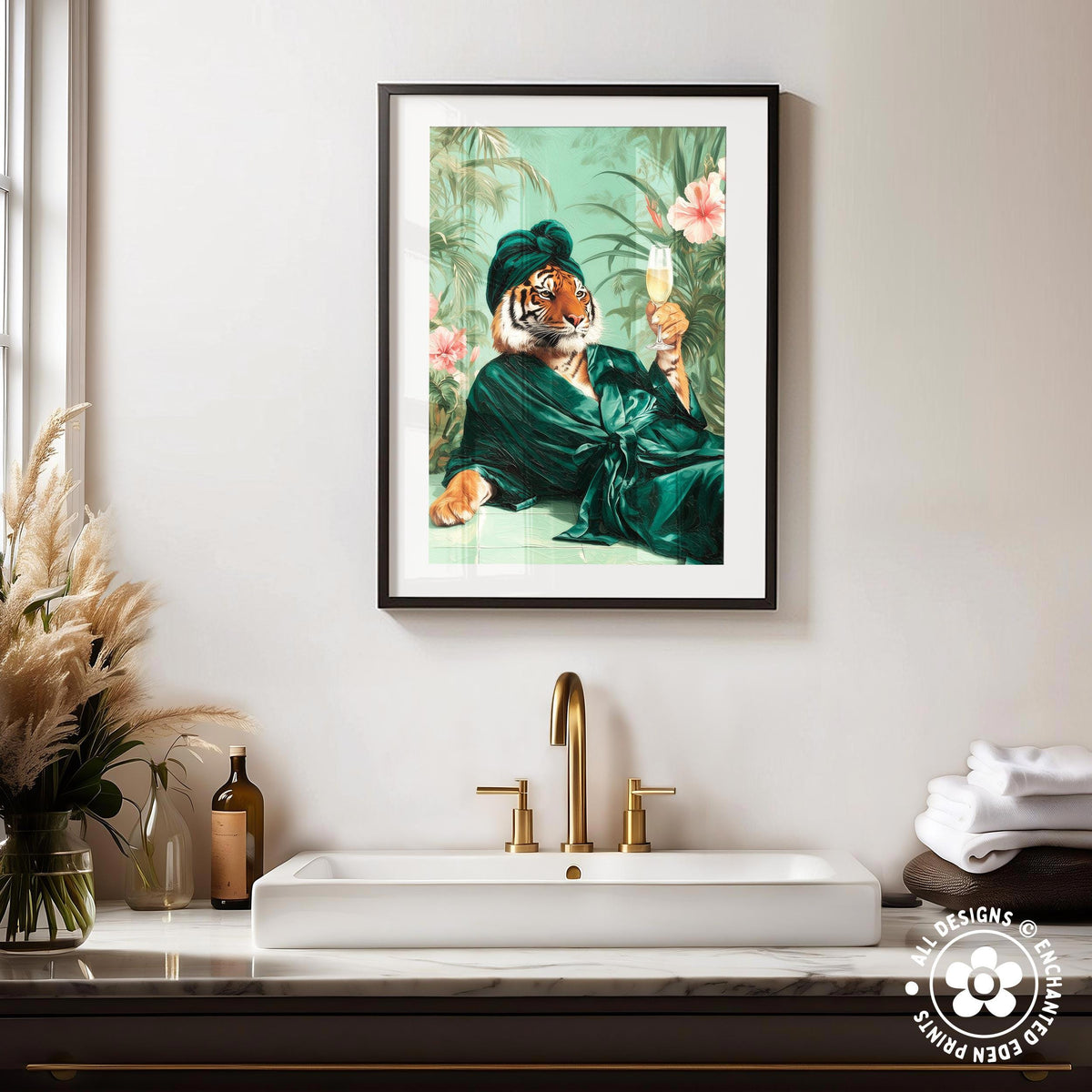 a framed painting of a tiger wearing a green robe and holding a glass of wine, hanging on a wall above a white sink with gold faucets.