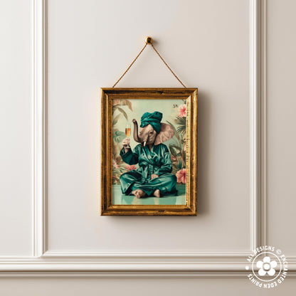 a framed painting of an elephant wearing a green robe and holding a drink, set against a tropical background.