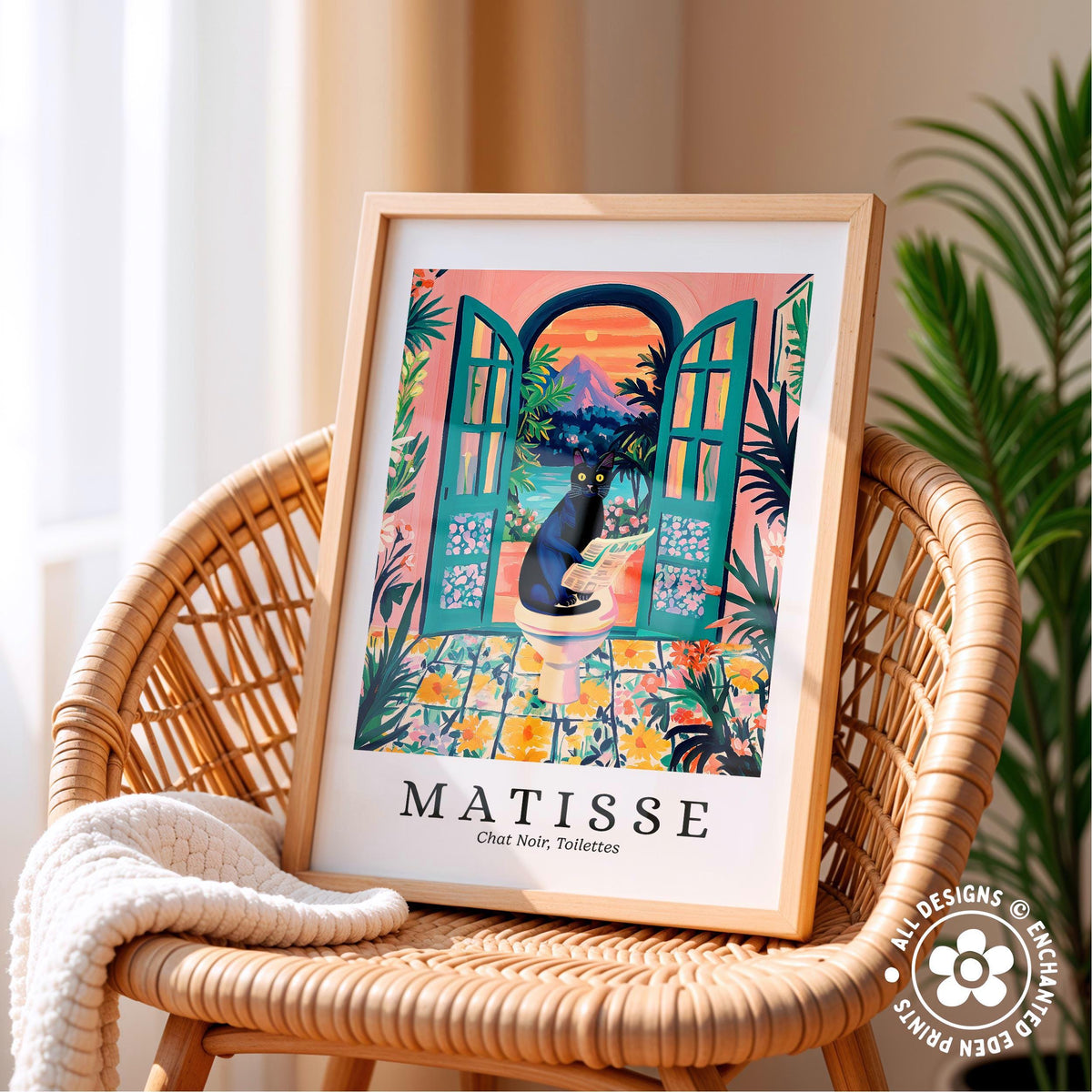 A framed print of a colorful illustration depicting a cat sitting on a toilet in a tropical setting, with a pink and orange background and a blue sky.