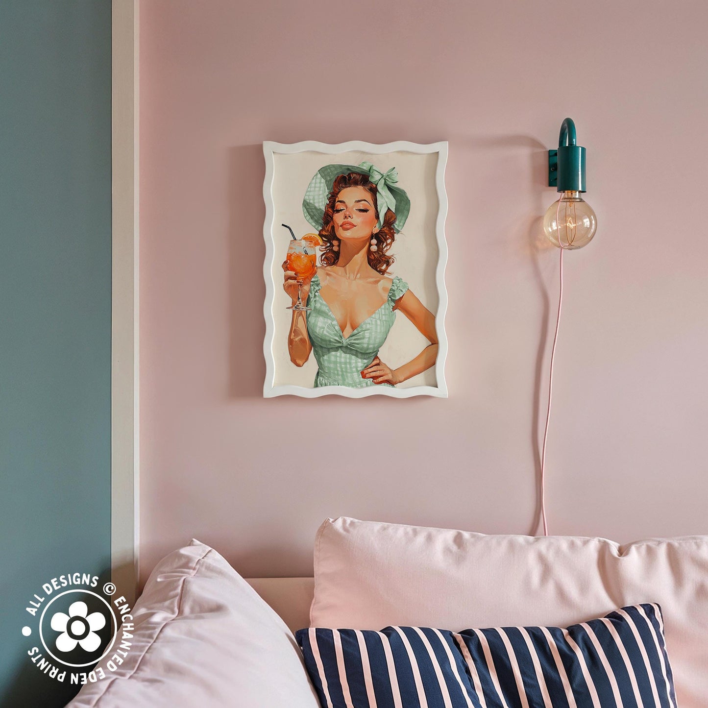 a framed vintage-style illustration of a woman holding a drink, hanging on a pink wall above a couch with striped pillows.