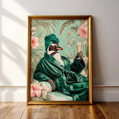A framed painting depicting a penguin wearing a green robe and holding a glass of wine, surrounded by tropical foliage and pink flowers.