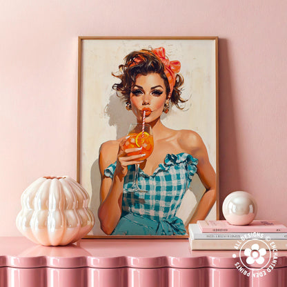 a framed painting of a woman in a blue and white checkered dress, holding a drink and wearing a red headband. The painting is displayed on a pink shelf, with a white vase and a stack of books placed next to it.