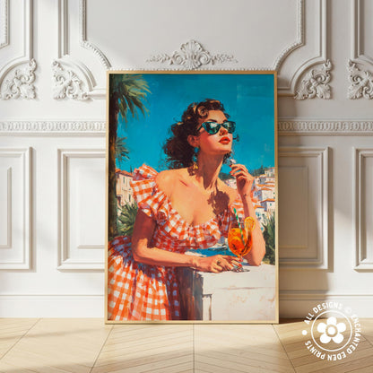 A framed painting of a woman in a red and white checkered dress, wearing sunglasses and holding a glass of wine, standing in front of a white wall with an ornate molding.