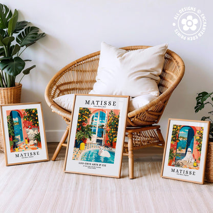 three framed prints of Matisse's "La Touristique" artworks, including "La Touristique" and "La Touristique" in the center frame, and "La Touristique" in the other two frames. The prints are displayed on a white floor, with a wicker chair and potted plants in the background.