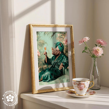a framed painting of a person in a green robe holding a glass of wine, surrounded by pink flowers and a teacup on a white shelf.