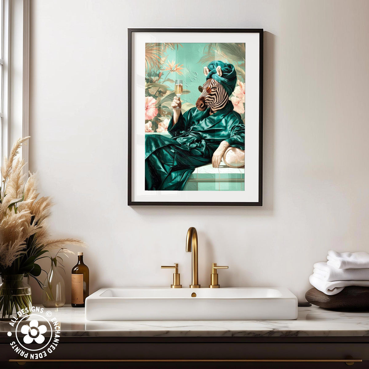 a framed painting of a zebra wearing a green robe and holding a drink, sitting on a bench in a tropical setting. The painting is hung on a wall above a white sink with a gold faucet.