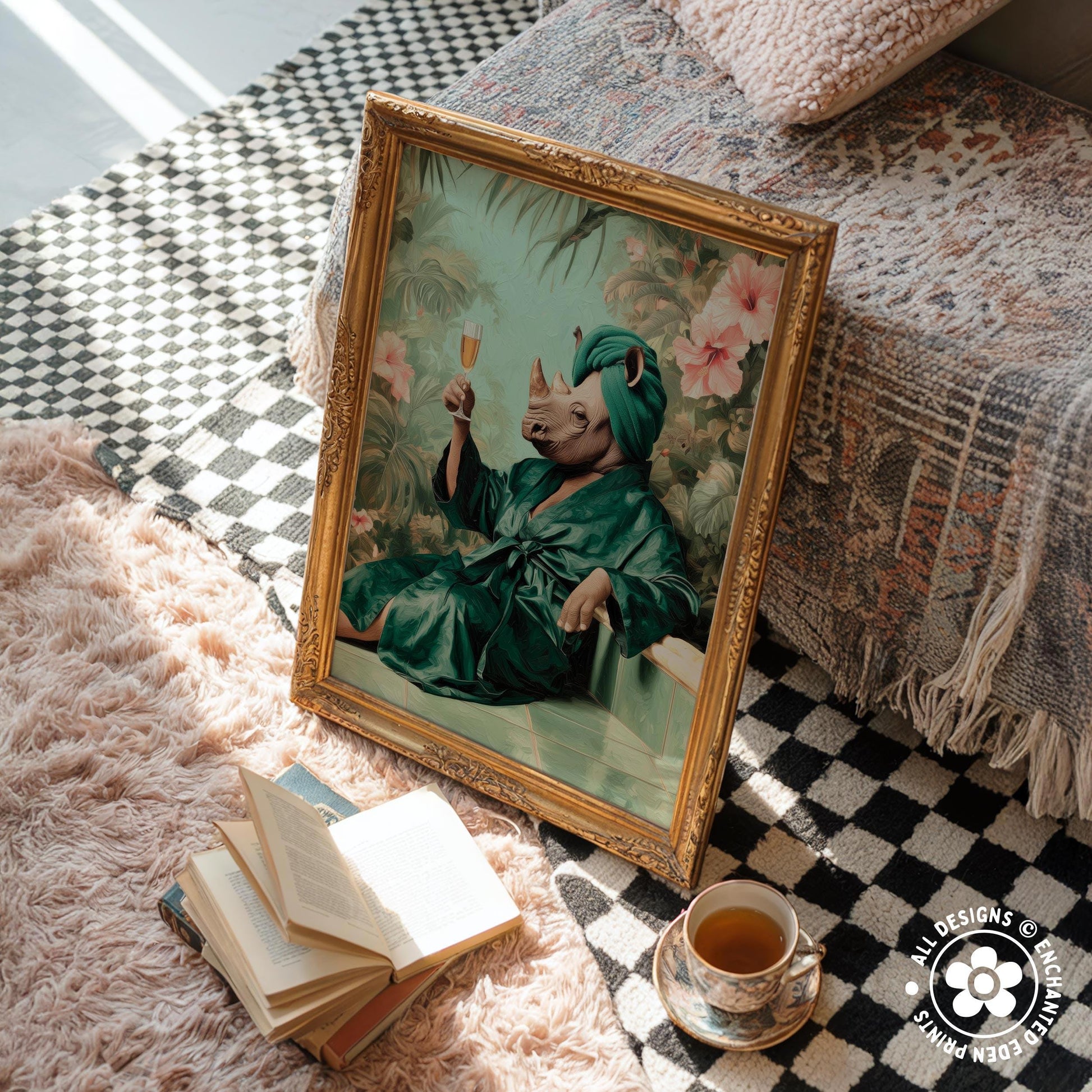 a framed painting of a rhinoceros wearing a green robe and holding a wine glass, sitting on a rug next to a stack of books and a cup of tea.