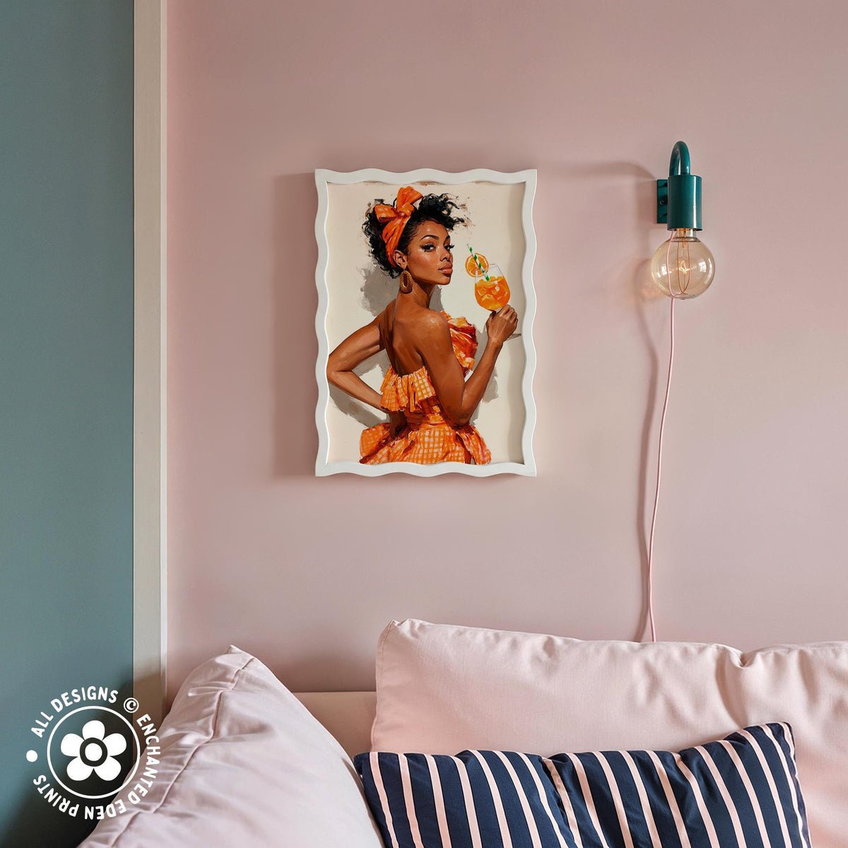 a framed picture of a woman in an orange dress, holding a drink, hanging on a pink wall above a couch with striped pillows.