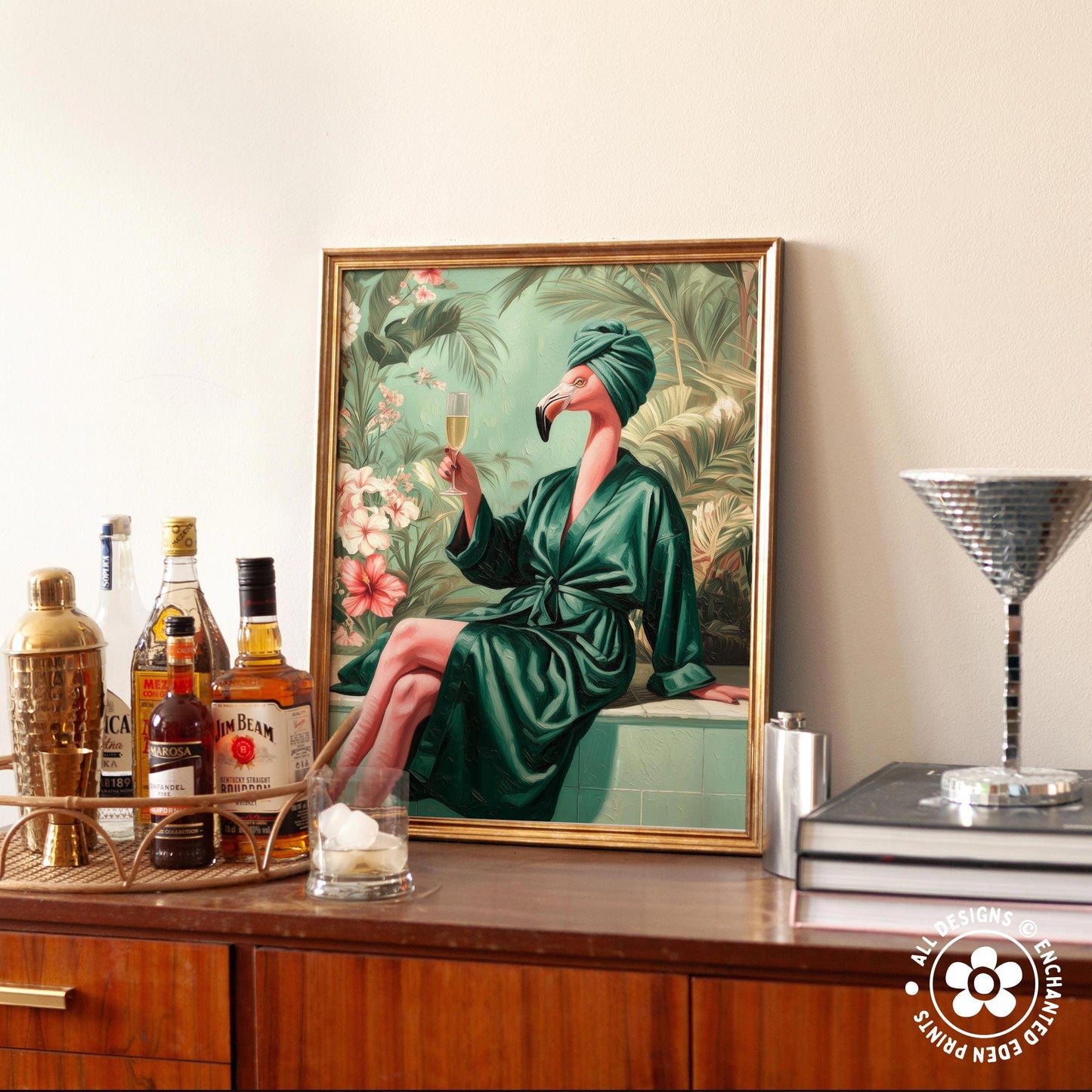 a framed painting of a woman in a green bathrobe holding a glass of wine, surrounded by tropical foliage. The painting is displayed on a wooden cabinet, with various bottles of alcohol and a cocktail shaker visible on the countertop.