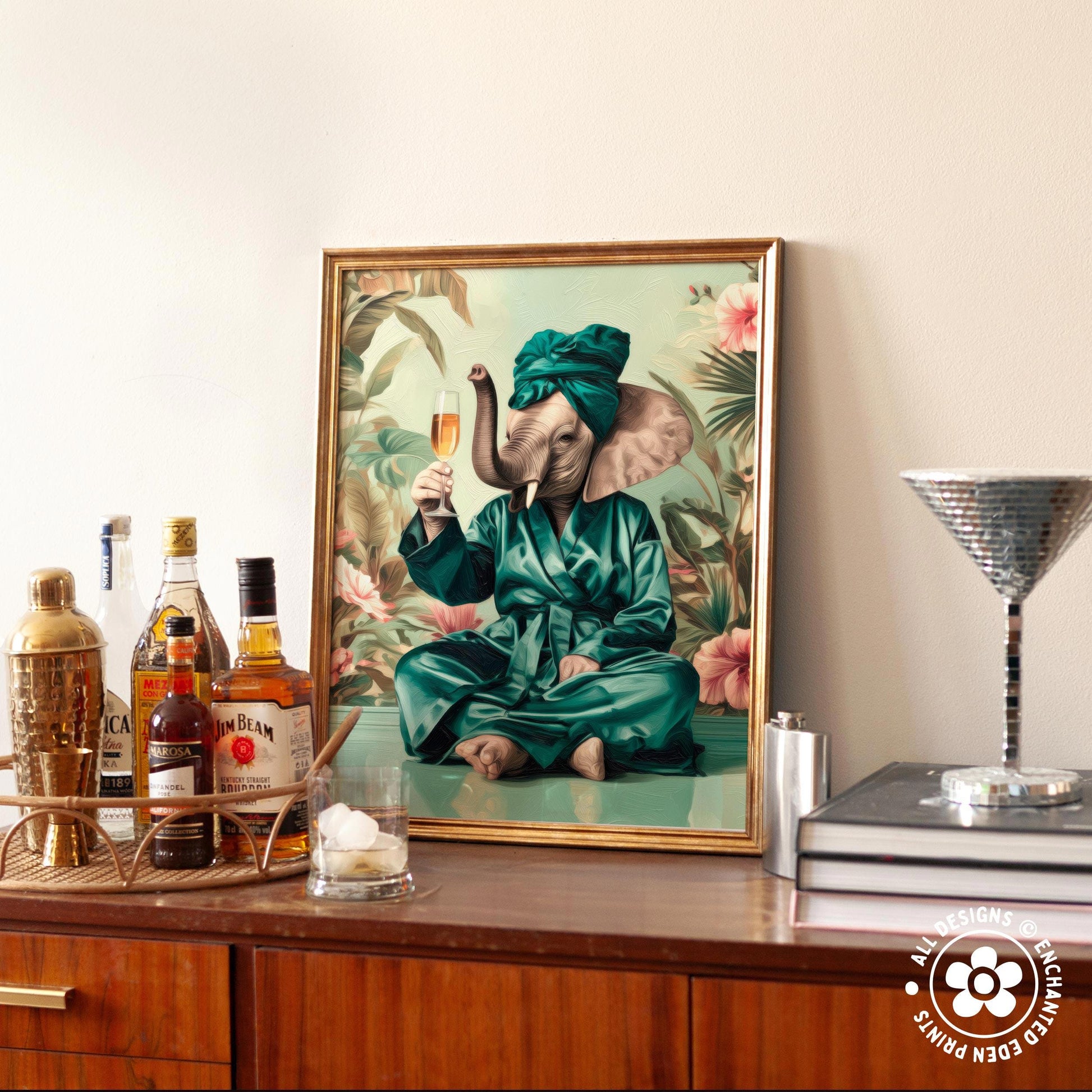 a framed painting of an elephant dressed in a green robe and holding a glass of champagne, sitting on a table surrounded by various bottles of alcohol.