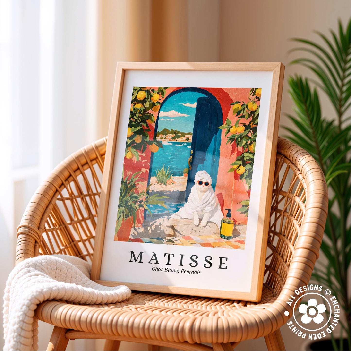 A framed poster of a cat sitting on a rock, with a colorful and whimsical background featuring a blue archway, orange and yellow flowers, and a body of water.
