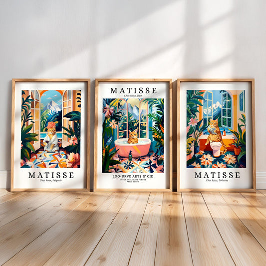 three framed prints of the famous artist Matisse, each featuring a cat in a different setting. The prints are arranged in a row on a wooden floor, creating a visually appealing display.