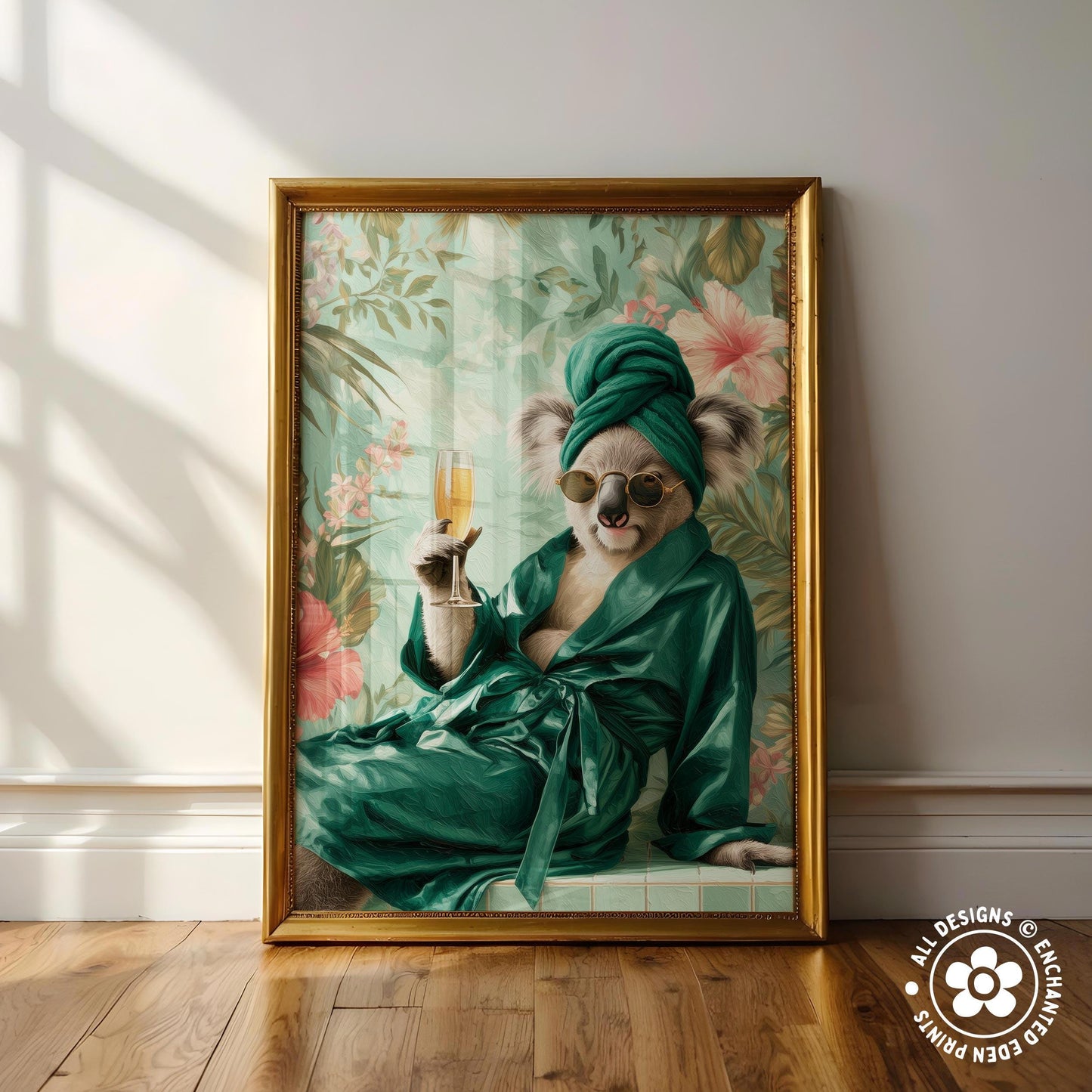 A framed painting depicting a koala wearing a green robe and holding a glass of champagne, with a tropical floral background.