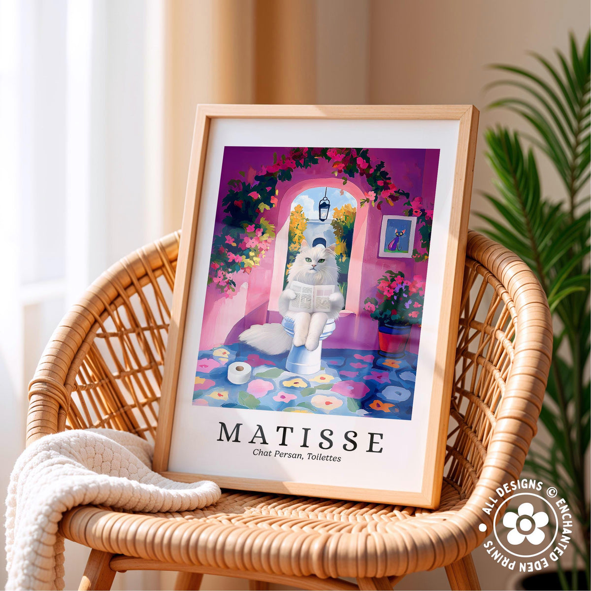 A framed print of a whimsical illustration depicting a cat sitting on a toilet in a colorful, floral-adorned bathroom.