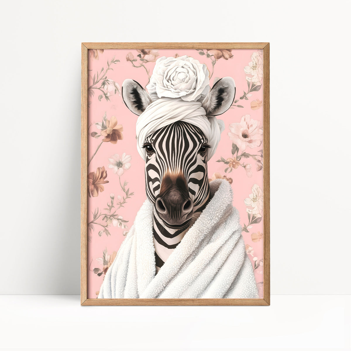 A framed print of a zebra wearing a white towel and a flower crown, set against a pink floral background.