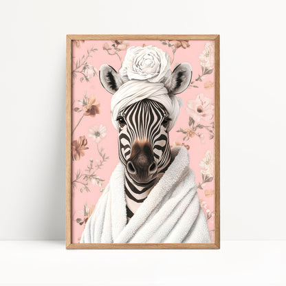 A framed print of a zebra wearing a white towel and a flower crown, set against a pink floral background.