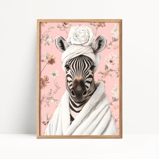 A framed print of a zebra wearing a white towel and a flower crown, set against a pink floral background.