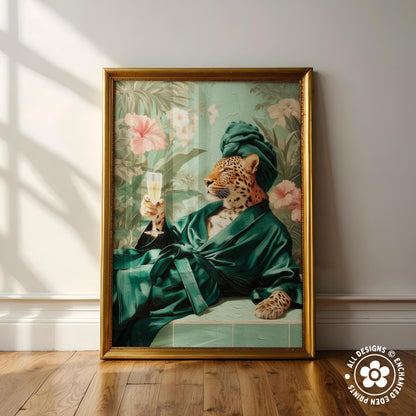 A framed painting depicting a leopard wearing a green robe and holding a glass of champagne, set against a tropical floral background.