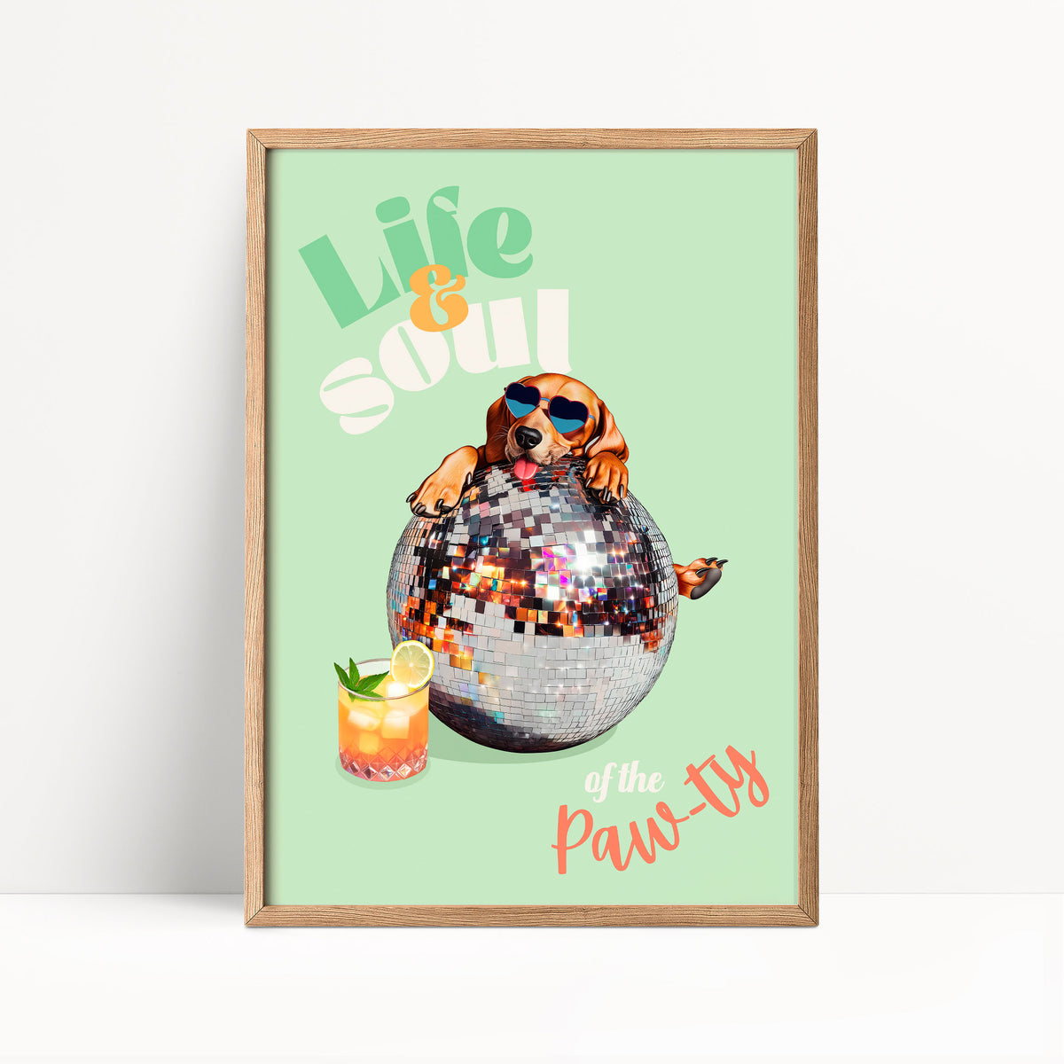 A framed poster with a dog wearing sunglasses and sitting on a disco ball, holding a drink, and the text "Life & Soul of the Paw-ty"