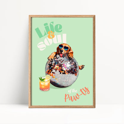 A framed poster with a dog wearing sunglasses and sitting on a disco ball, holding a drink, and the text "Life & Soul of the Paw-ty"
