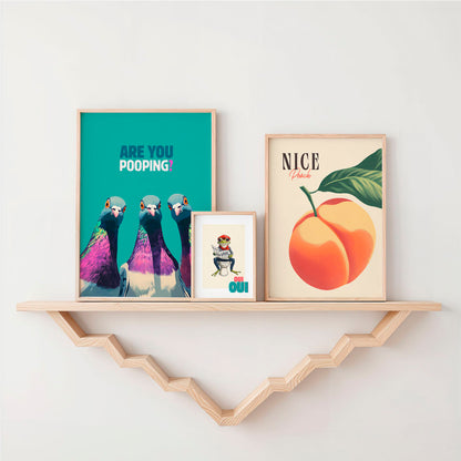 a shelf with a couple of framed pictures on it