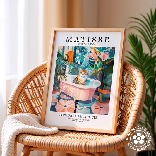 A framed poster of a cat sitting in a bathtub, surrounded by tropical plants, is displayed on a wicker chair.