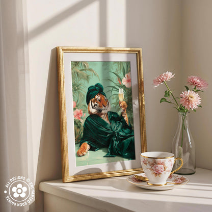 a framed painting of a tiger wearing a green robe and holding a glass of wine, placed on a white shelf next to a vase of pink flowers and a teacup.