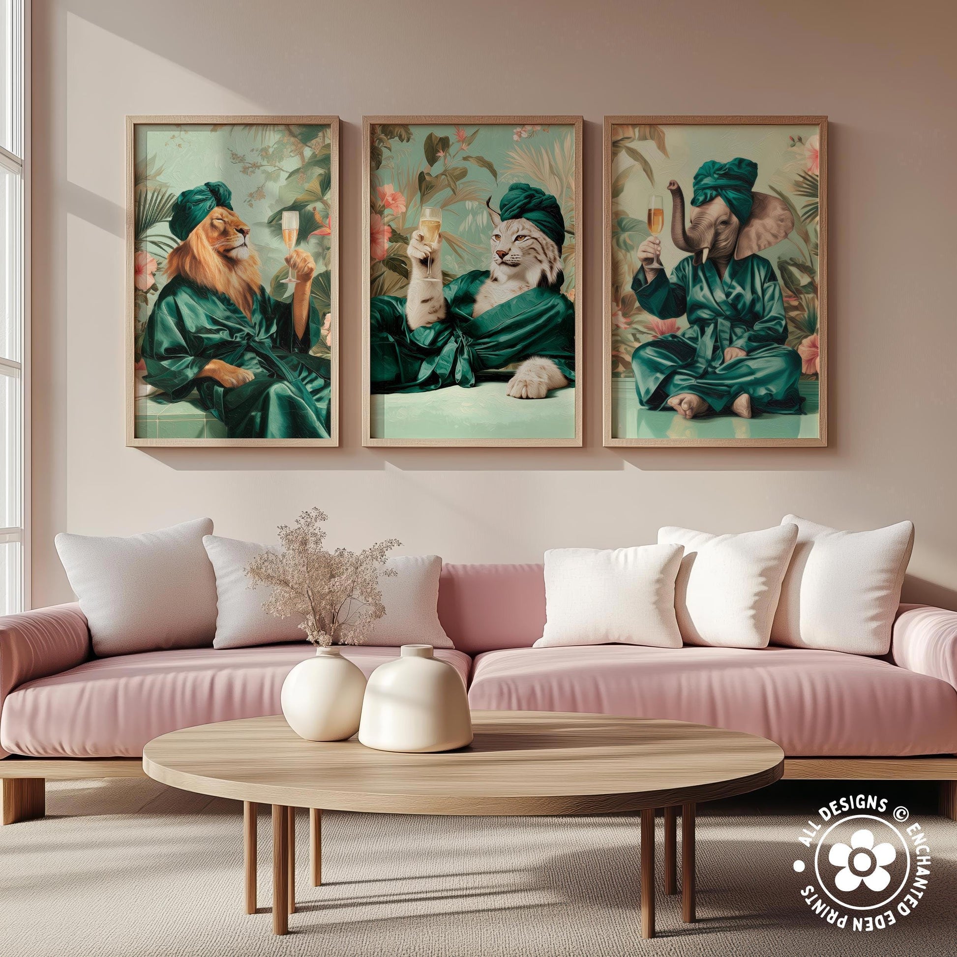 a living room with a pink sofa and a wooden coffee table. Above the sofa, there are three framed paintings depicting animals dressed in green robes, each holding a wine glass.