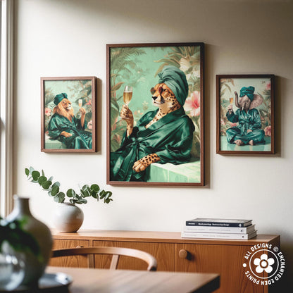 a collage of three framed artworks depicting animals in green robes, including a cheetah, a lion, and an elephant, all holding wine glasses. The artworks are displayed on a wall above a wooden cabinet, which also has a vase and some books on it.