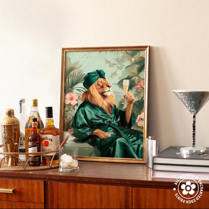 a framed painting of a lion wearing a green robe and holding a glass of champagne, surrounded by various bottles of alcohol and a cocktail shaker on a wooden surface.